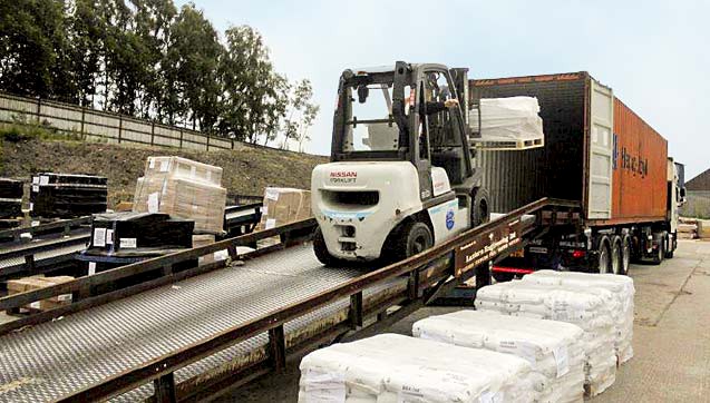 Loading goods using one of our three mobile loading ramps.